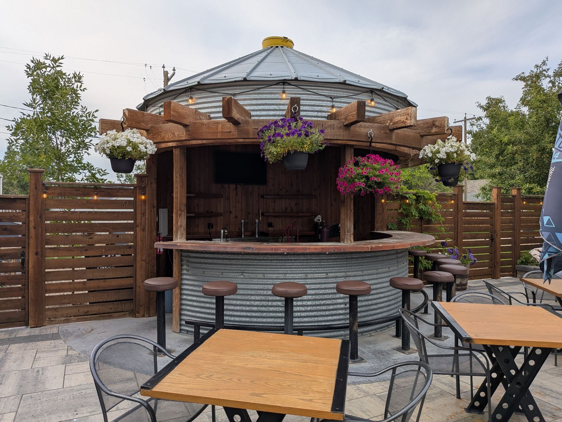 Binzebo built as an outdoor bar with hanging flower baskets